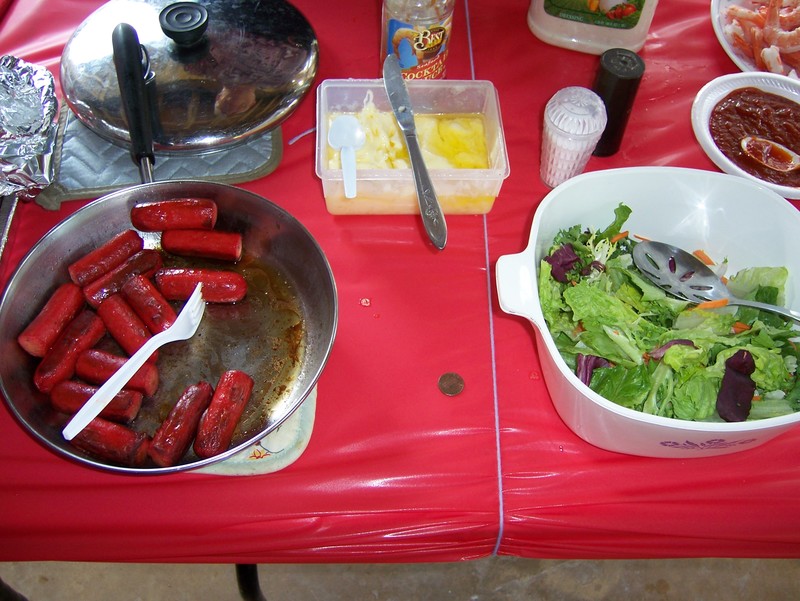 Hawaiian Red Hot dogs and tossed salad with purple leaves
