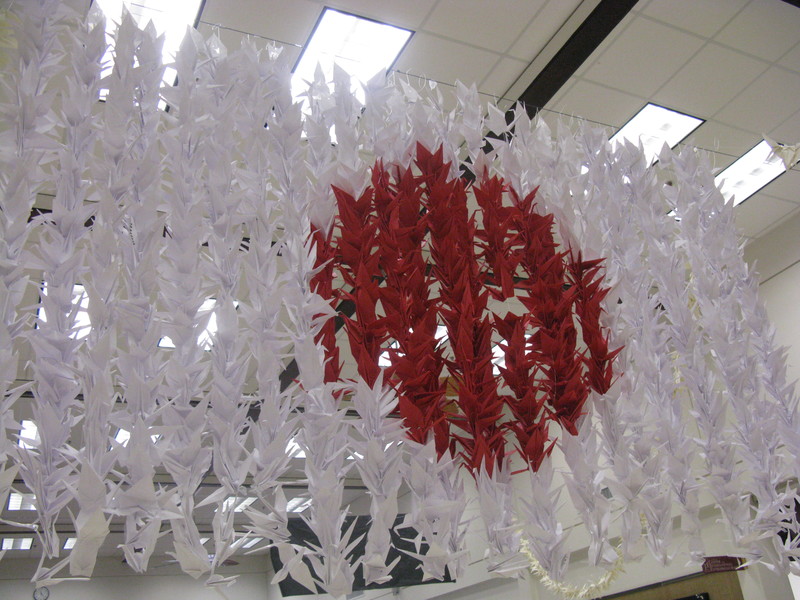 Japanese Flag hanging from the ceiling. It is made out of 1000? paper cranes.