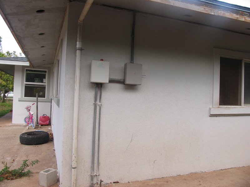 Here is another view of the NW corner of the house. Notice the sewer pump alarm box is here. You can also see the front entry addition.