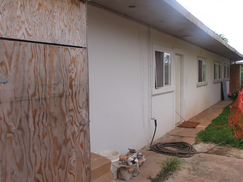 Back of house. storage box? water heater? who knows. maybe window next to it? who knows.