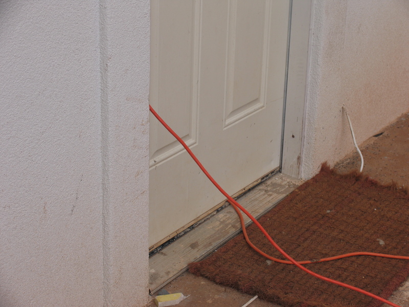 Back door with electrical cables running to house that's being built.