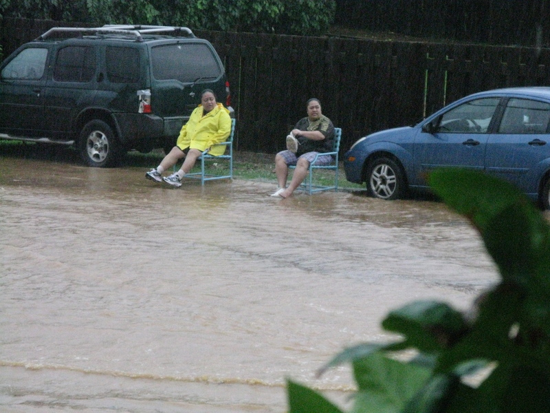 Sitting watching the flood. There is water totally in their house.