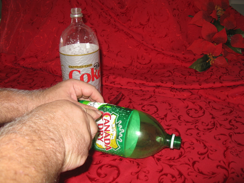 Pinch the bottle so that you can start cutting it in half.