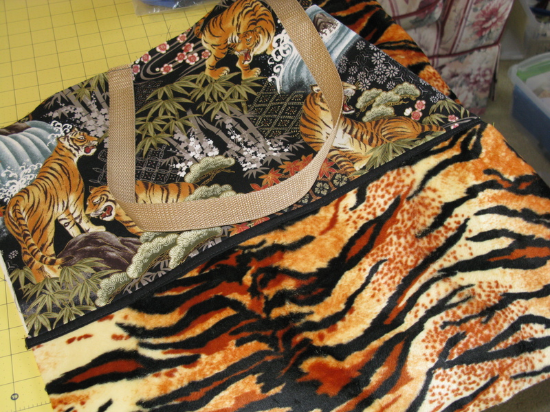 The bottom half of the bag came from a long tube of material I had that was sewn into a snake shape. I was planning on decorating a room into a jungle. That never happened, and I thought it went wonderfully with her tiger material. :-)