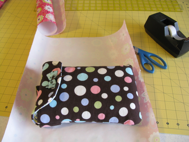 Bag with Nursing cover and wipes inside. It has a wrist strap so you can carry it hands free. :-)