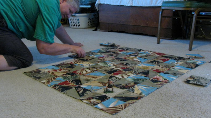 Lois laying out the quilt blocks to see if they will look good together.