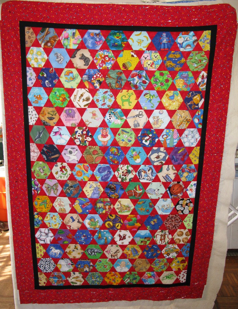 Quilt Top that Doris finished. Now she has it with the backing and batting and pinned together.