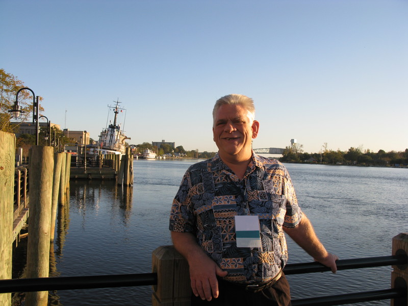 Don on the Wilmington Waterfront. The US Coast Guard boat in the back is leaning to one side so that they can clean the other side. This is the Cape Fear river.