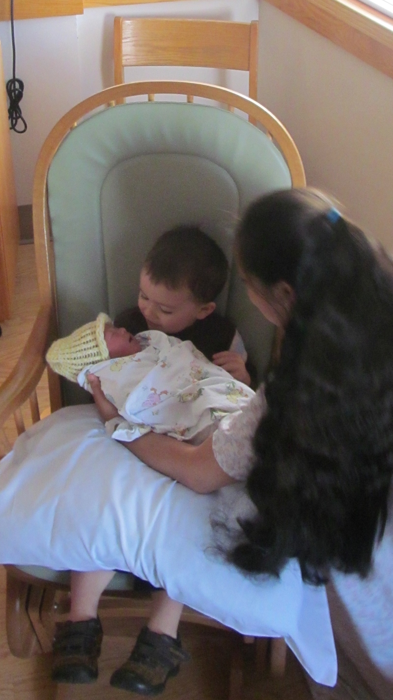 Kekoa was born June 8th, and on the 9th we went to visit him. Kili holding the new baby.