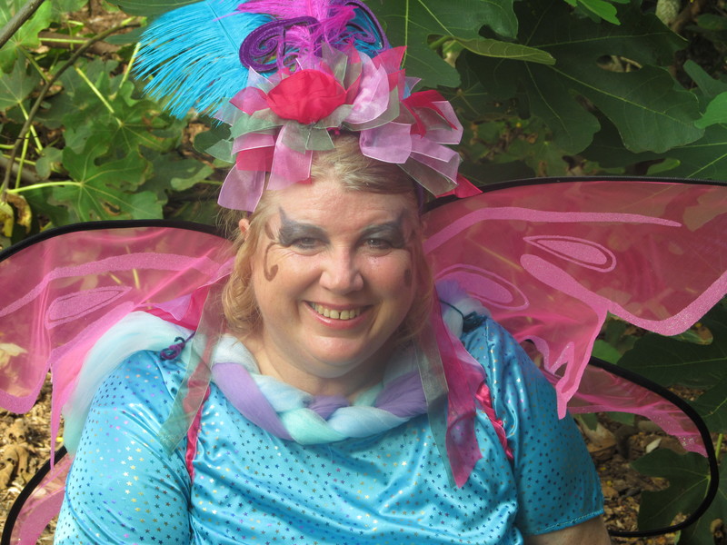 Then I wanted a head piece. I bought the headband with flowers and antennae. I added three feathers to the top.