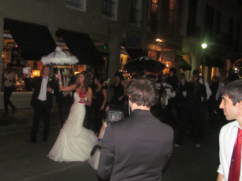 A wedding party parading down Bourbon street.