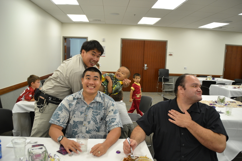 Michael Lau and Tolo Lawrence with David and son jumping into the background.