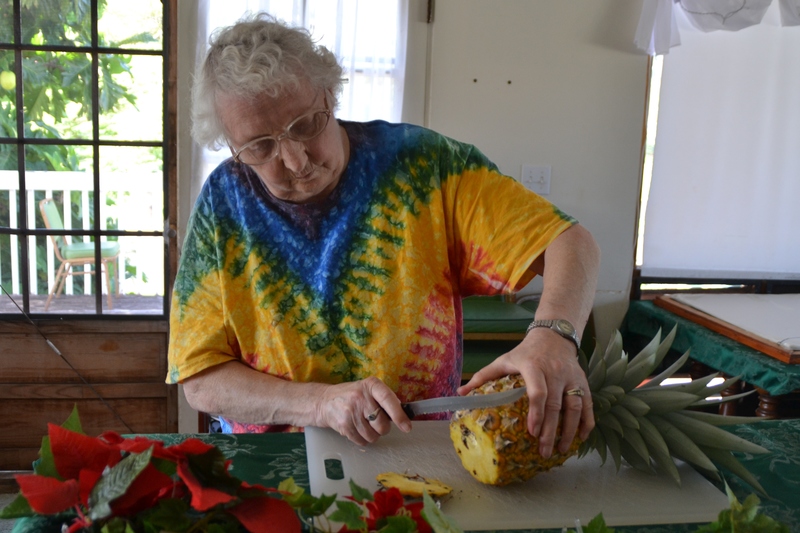 Jean is cutting the pineapple that grew on Lois and Don's front porch in Laie