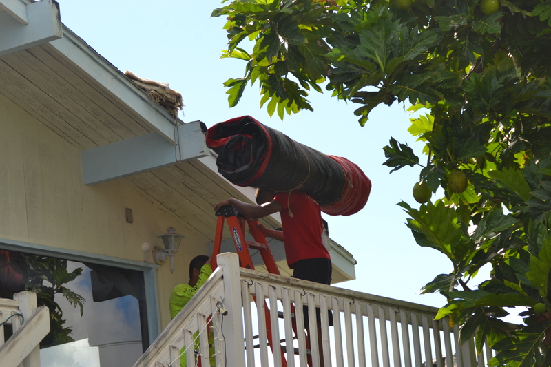Tarps headed up to the roof.