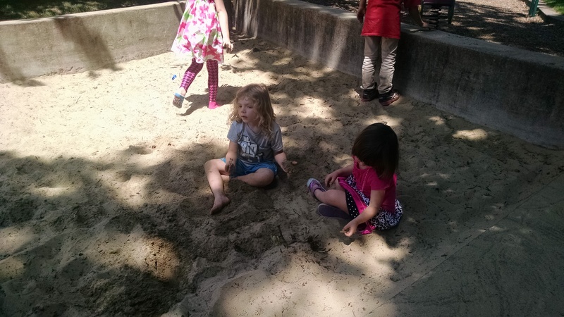 Emily and new friends in the sandbox.