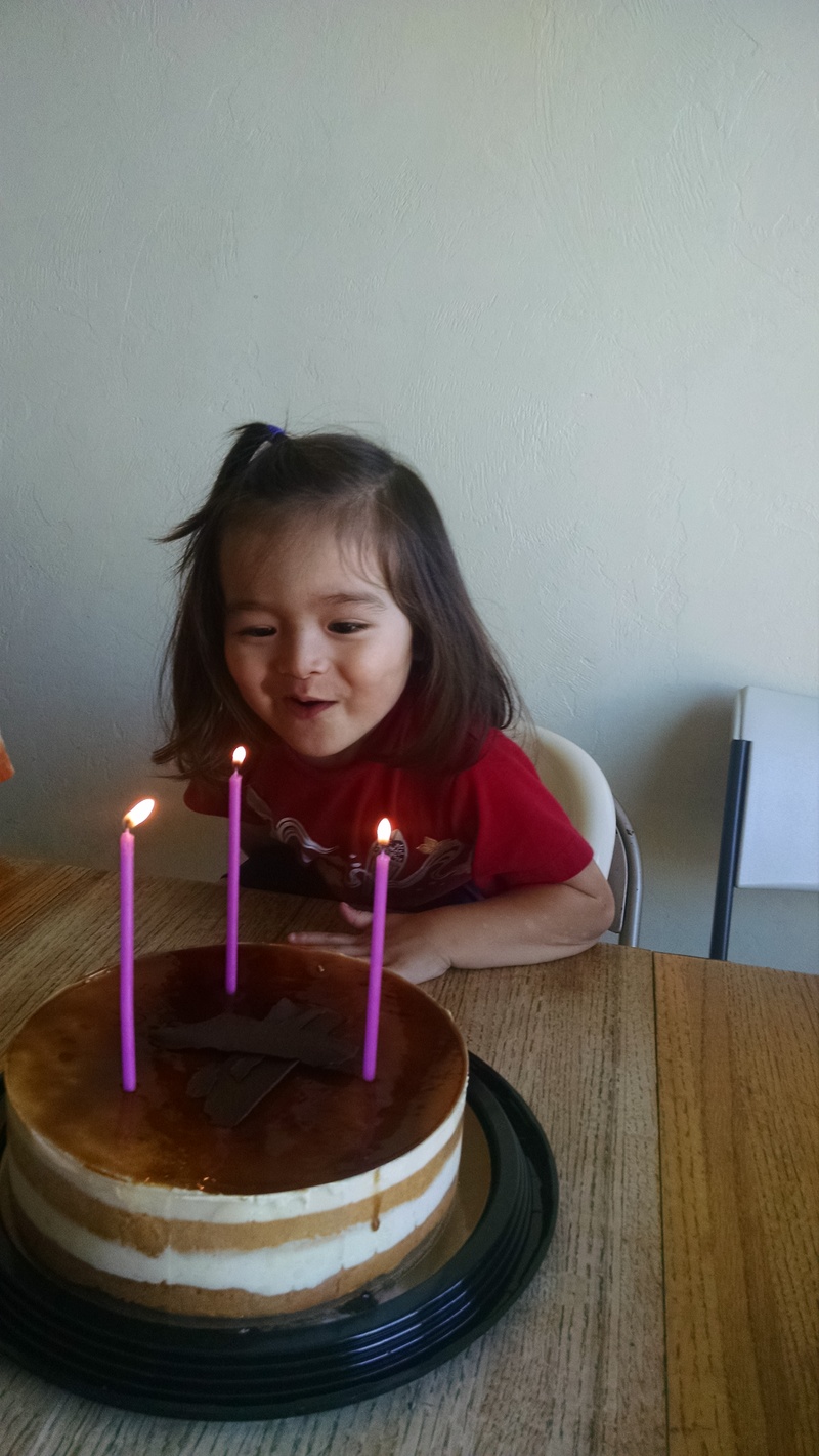 Kekoa blowing candles.