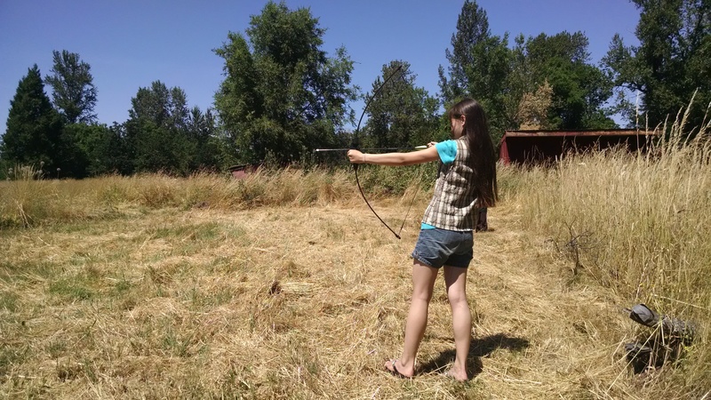 Latia trying out the bow and arrows.