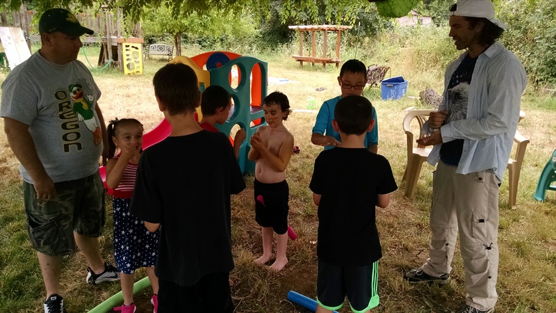 Doing "Rock, Paper, Scissors" to see who gets to hit the pinata first, with Ron Williams and Shaun Parry.