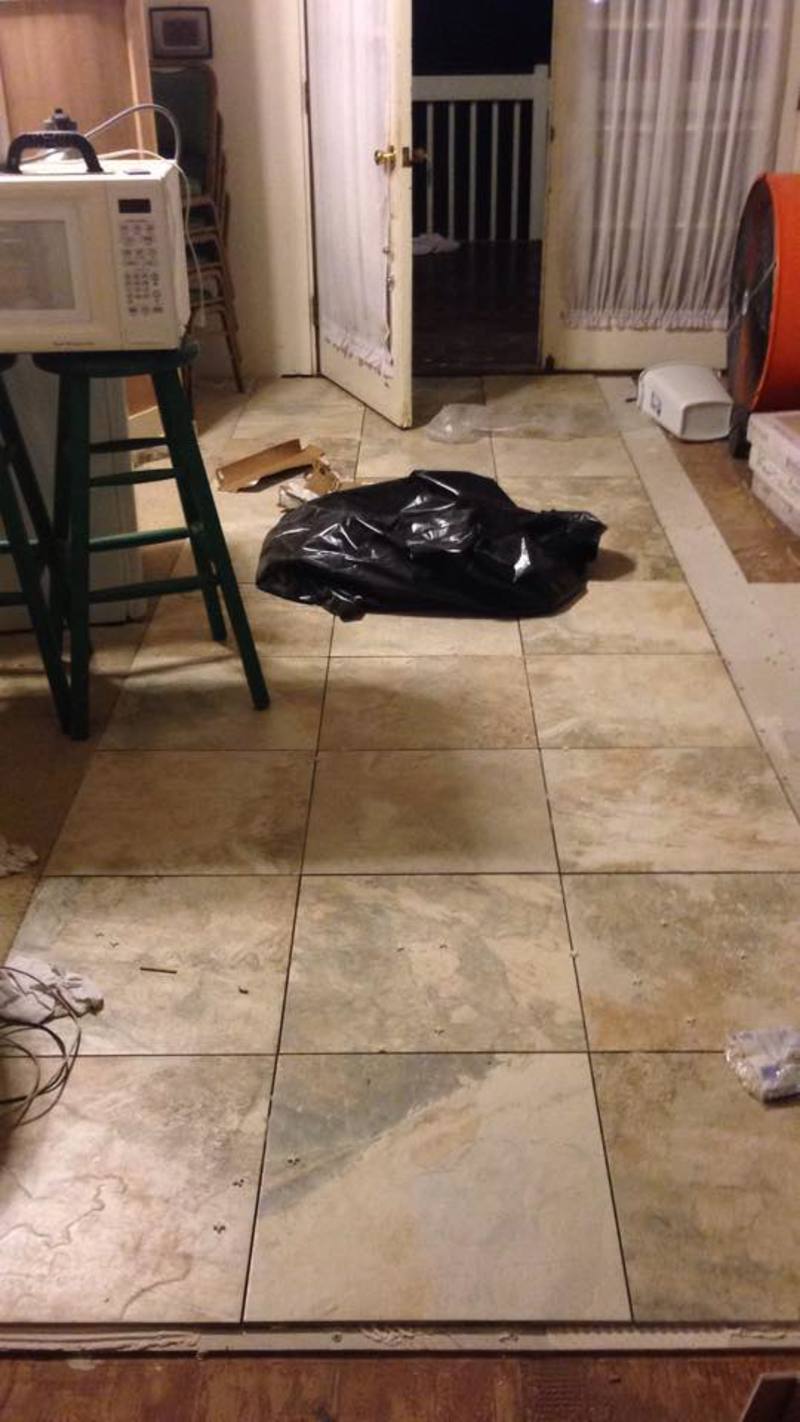 You can see new kitchen flooring being installed.