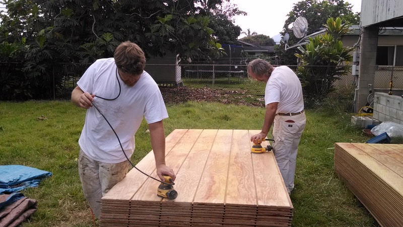 Fred and Erich are sanding theT1-11 in preparation for primer paint.