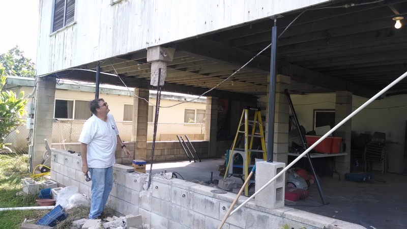 Carl Minks inspecting the removed portions of the center east pillar.