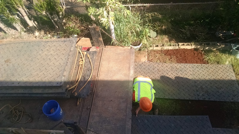 The electrical company comes for another day of work. They are laying more pads down just so they don't break the pipe again.