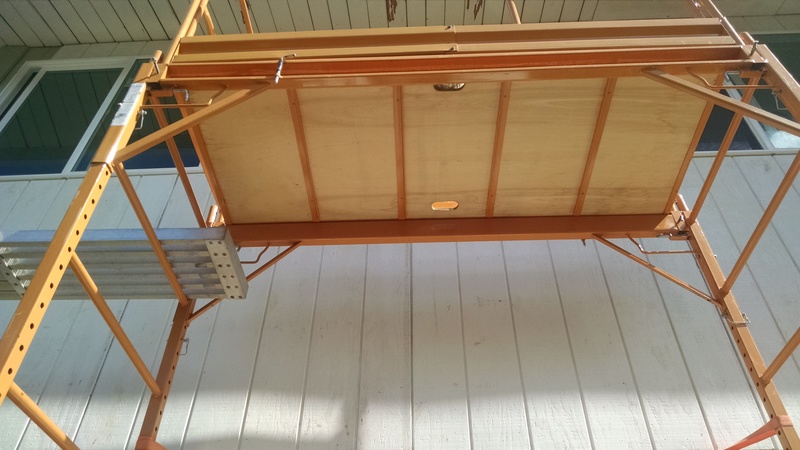 Looking up at the new siding covered with the T-111.