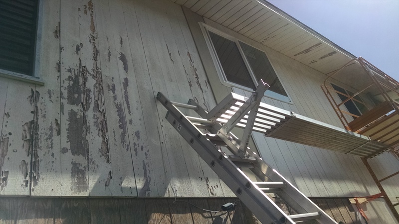 Powerwashed house that hasn't been replaced, and the last bedroom window that hasn't been replaced. You can see the new siding progressing.