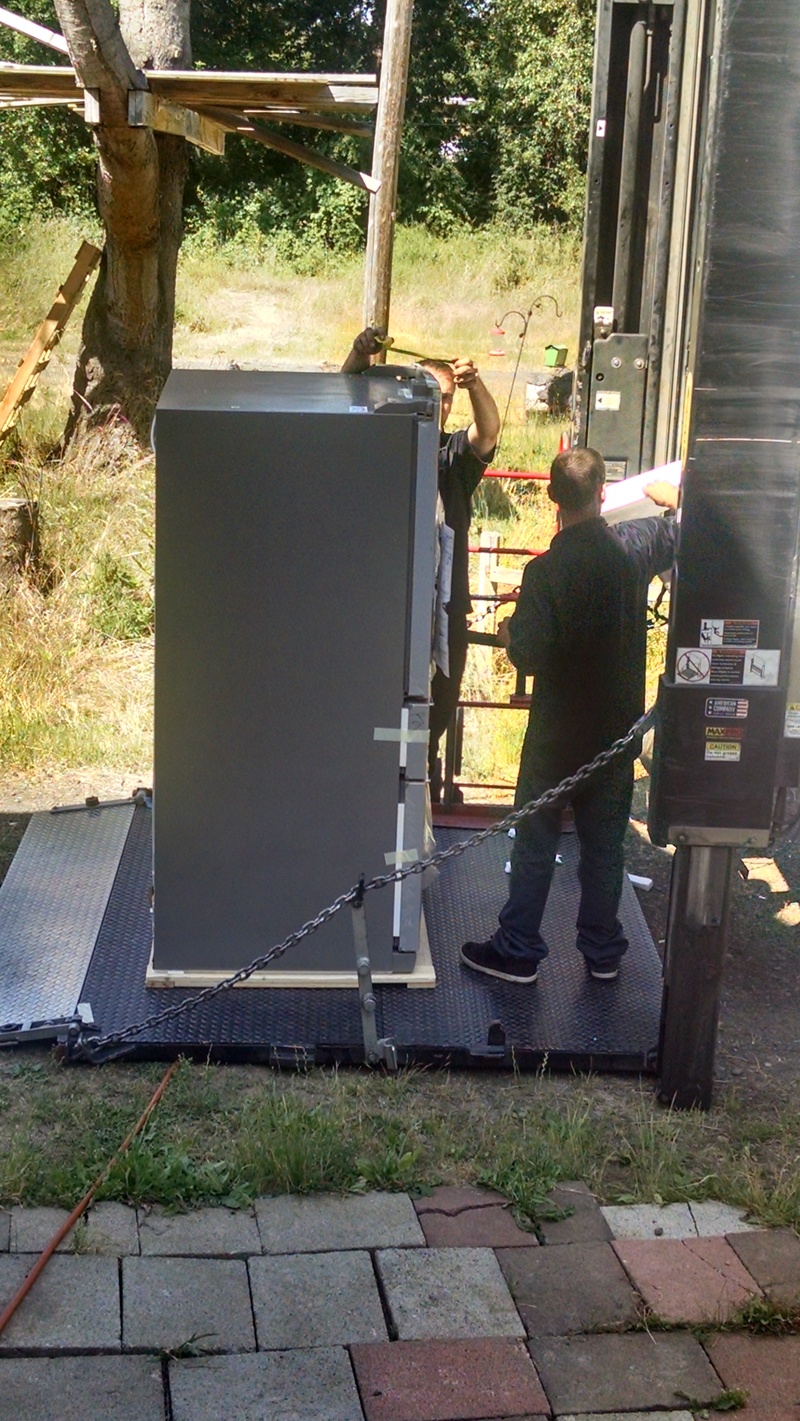 Men taking the packaging off.