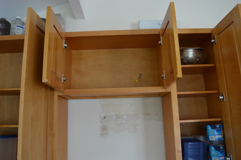Kitchen main cabinets above stove and south of stove