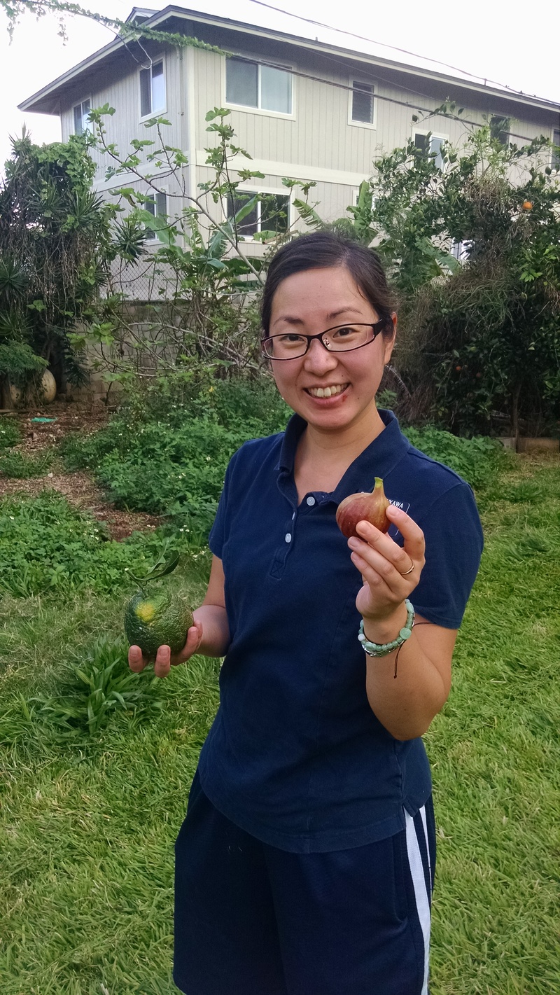 Sister Furukawa is holding a fig. She is also holding a Tangelo. I think it is a cross between a Tangerine and an Orange.