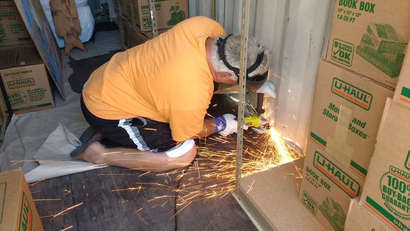 Don cutting Lois's container door.