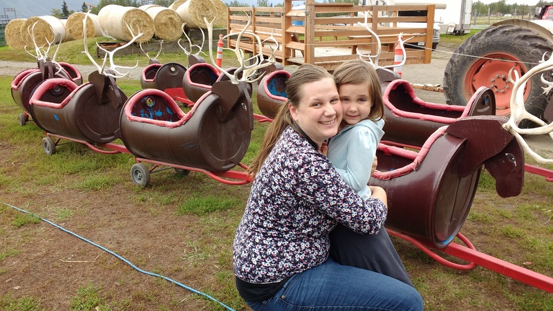 Stacia, Emily, and the Reindeer Ride. Which one has the red nose?