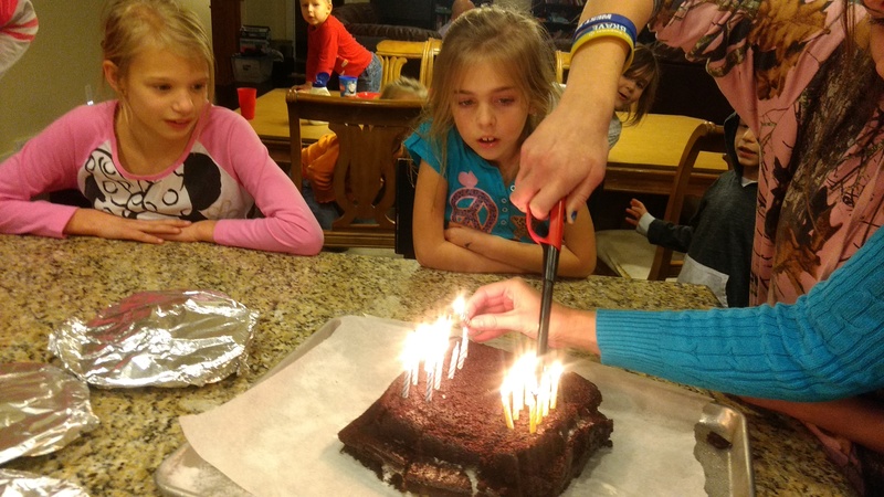 Lighting the candles for the February birthday girls.
