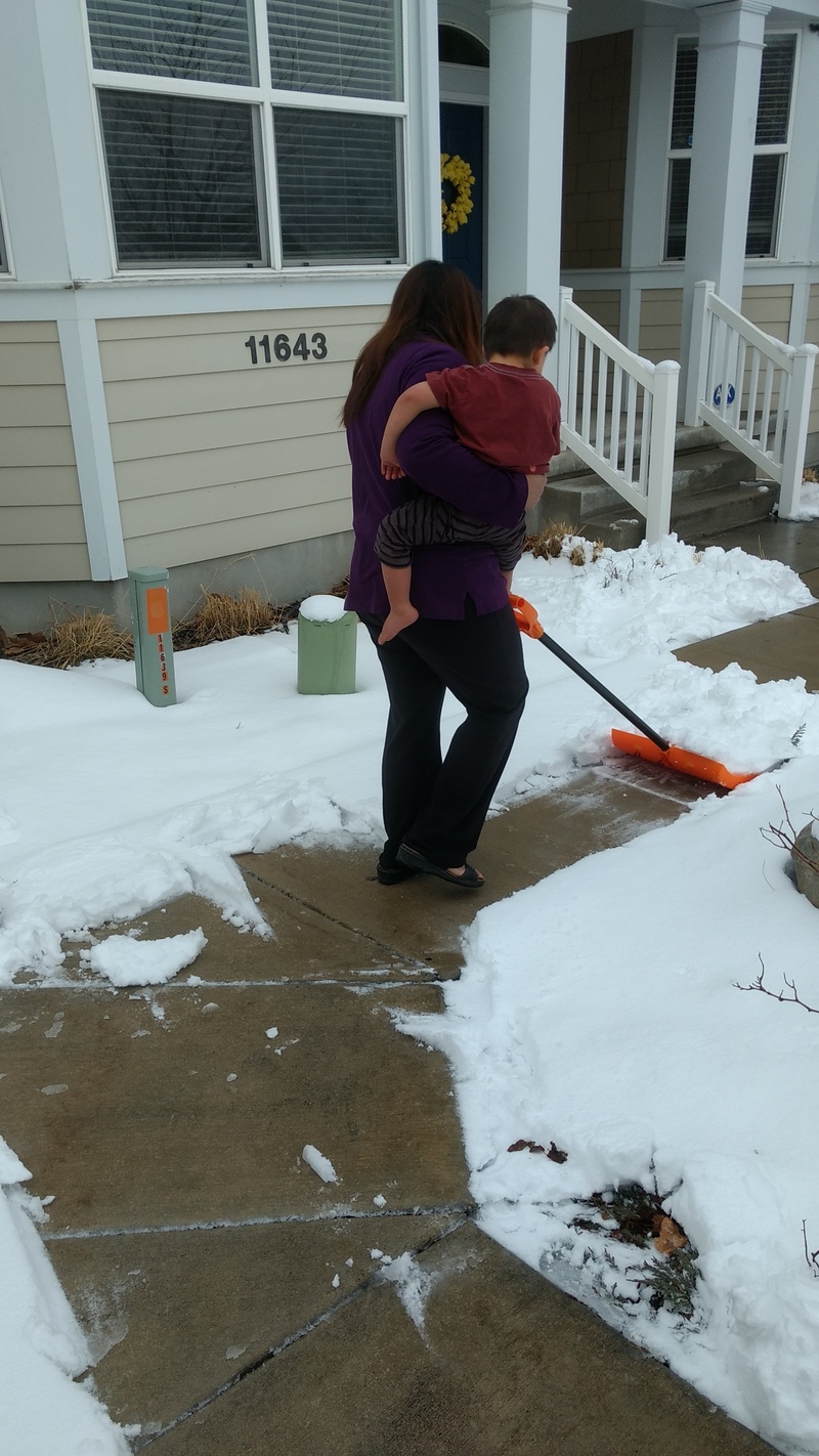 Ann clearing the walks one handed.