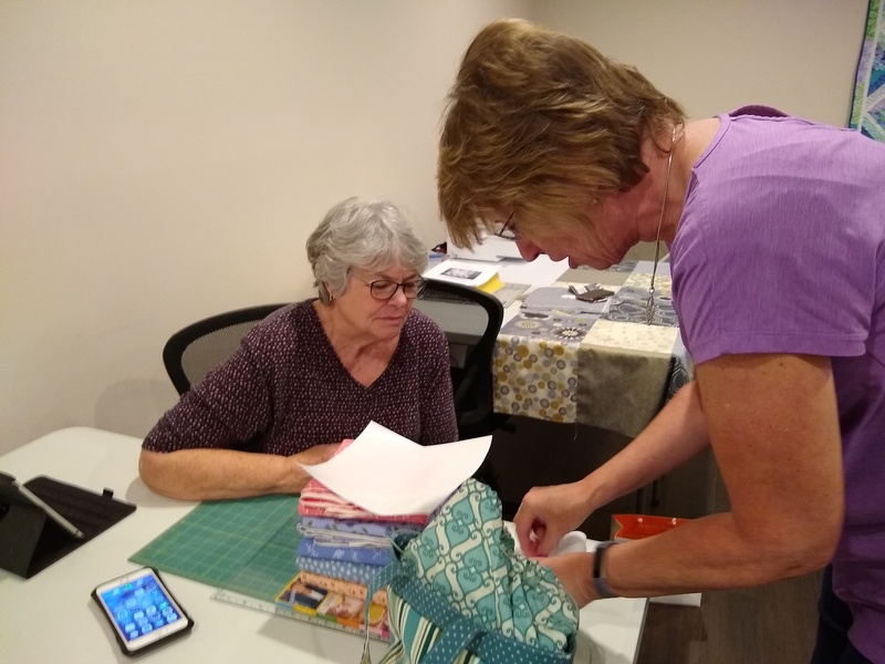 Gerene and Sally discussing quilt techniques.