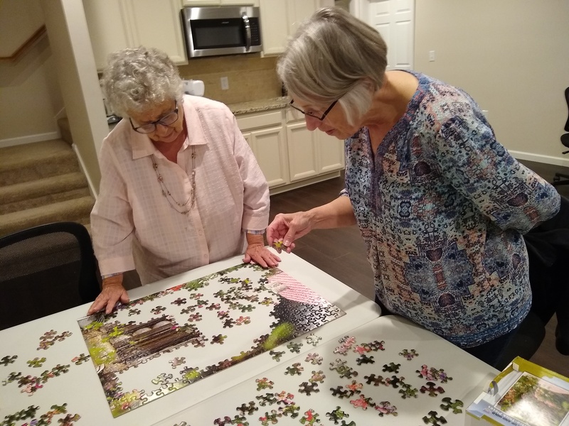 Connie and her sister Vicky working on a jigsaw puzzle.