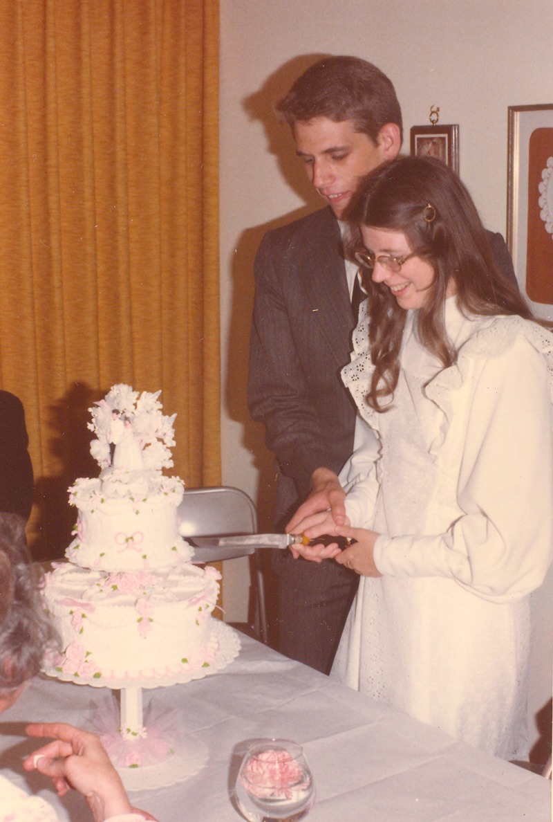 Don and Lois cutting wedding cake.