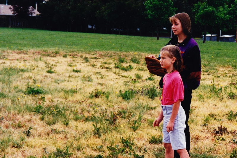 Stacia and girl from church, in the large field behind church.