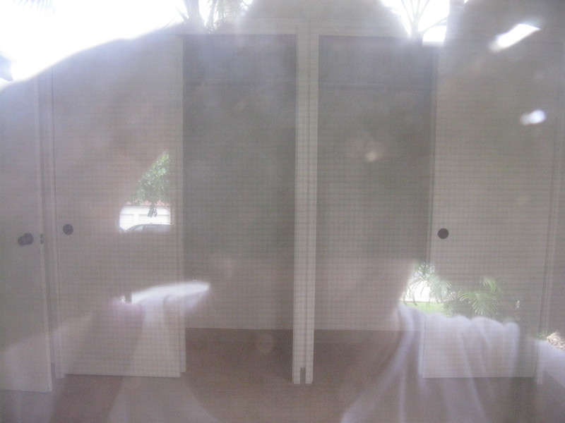 As you look at the house there's a front door with a window on the right. That is the bedroom/study that is downstairs. Here's a picture of the closet. LOL All pictures are taken through glass jealosies.