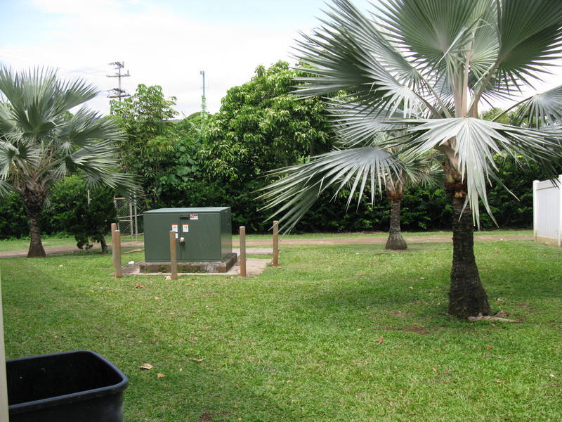 To the right/west of the house is a green area between unit 10 and 9. The garbage can in the pic is against your house.