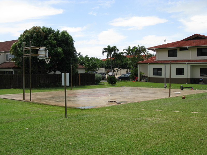 Basketball court by playground.