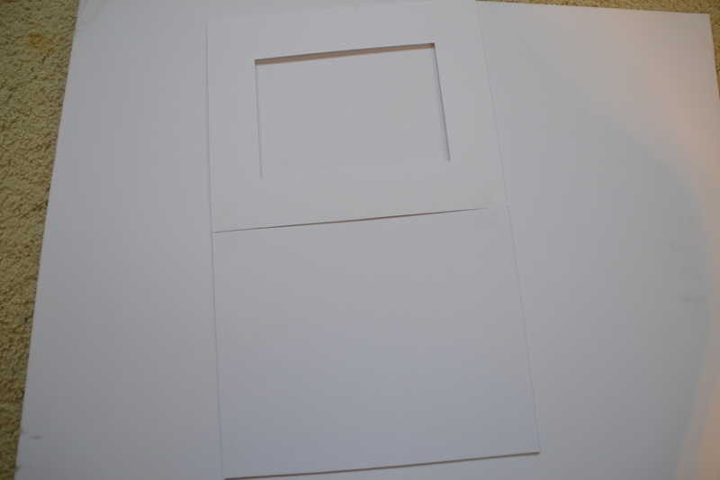 Step 1: Place a front and back mat on the table and line them up precisely and tape 2-3 pieces of tape to make a hinge.
Step 2: Place the picture in the correct position, and check it before taping it down on the edges.